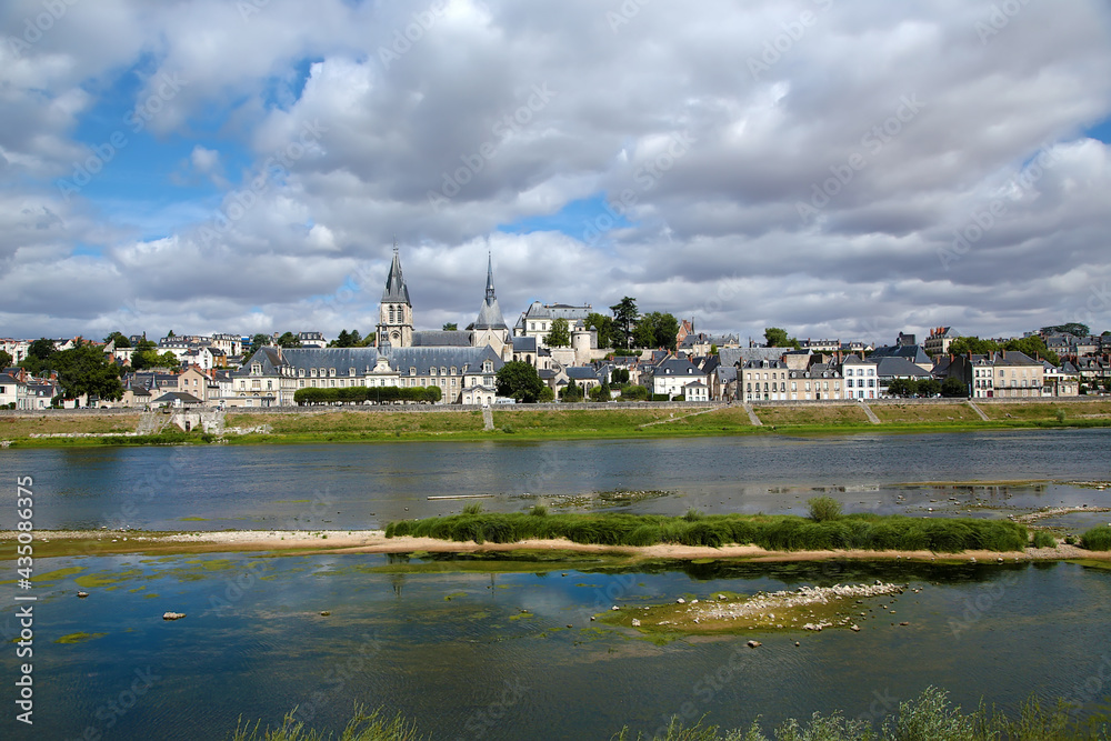 Blois, France. Summer landscape: embankment of the Loire River, Abbey of Saint Lomer, Church of Saint Nicholas, Royal Castle 