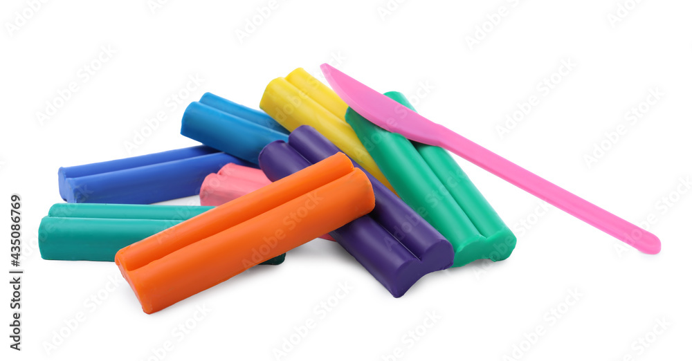 Many different colorful plasticine pieces and sculpting knife on white background Many different colorful plasticine pieces and sculpting knife on white background