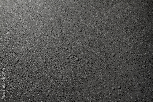 Water drops on a gray surface, a beautiful pattern of water splashes on the background photo