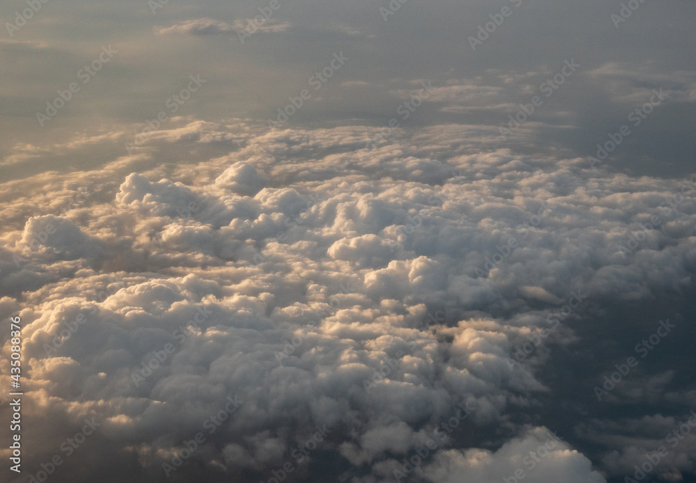 sunset over the clouds from cruising altitude 
