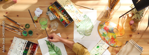 Young woman drawing at table indoors, top view. Banner design