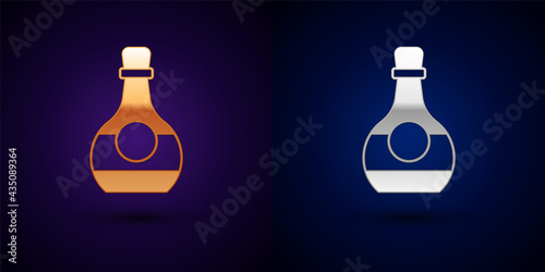 Gold and silver Bottle of cognac or brandy icon isolated on black background. Vector