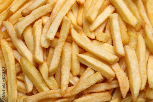 Yummy French fries as background, top view