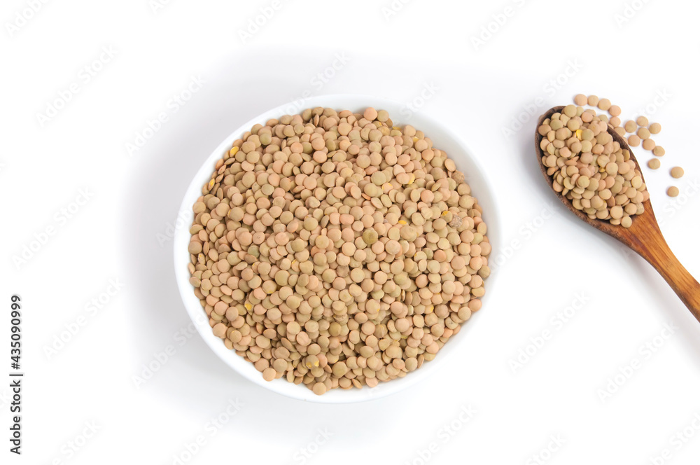 plate and wooden spoon full with lentils on white background isolated close up