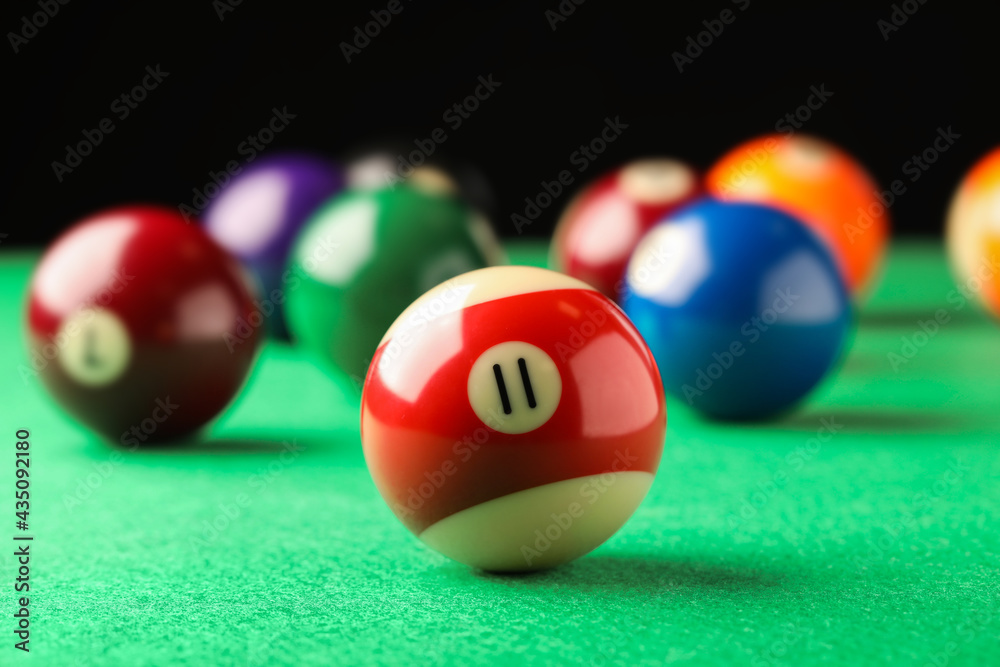 Billiard ball with number 11 on green table, closeup Billiard ball with number 11 on green table, closeup