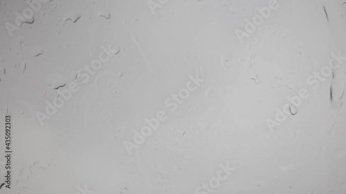 Water droplets on the windows of the car in the rain and storms, the transparent glass is covered with water vapor in cloudy weather.