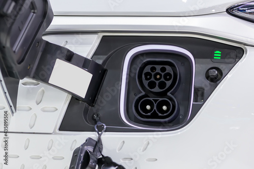 Charge port on an electric car, Ev Charging Port on electric car. Electronic car charging devise publicly installed. EV charger or electronic vehicle charger.