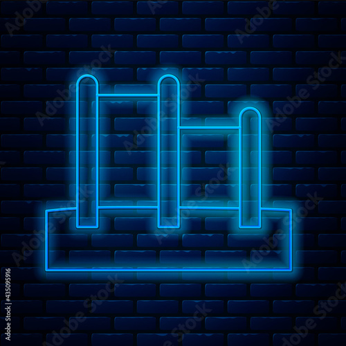 Glowing neon line Sport horizontal bar icon isolated on brick wall background. Vector