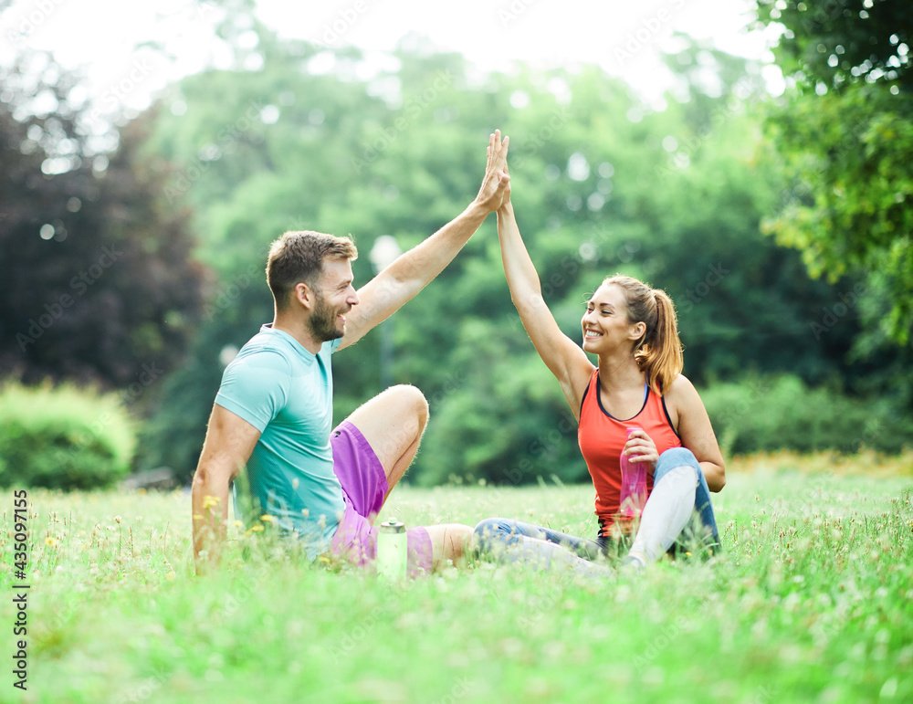 Naklejka premium fitness woman park exercise lifestyle outdoor sport healthy couple nature active young fit training athlete
