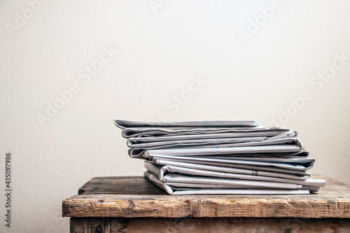 Old newspapers on wooden table	