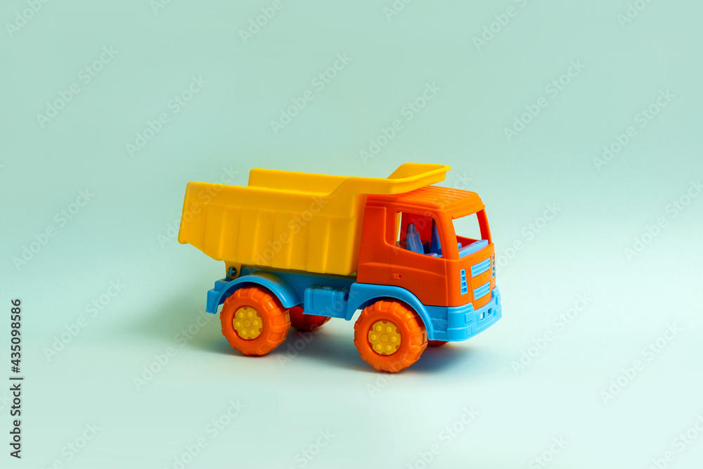 Plastic toy car on a blue background