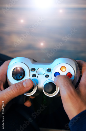 Overhead shot of a man's hands holding a video game controller.