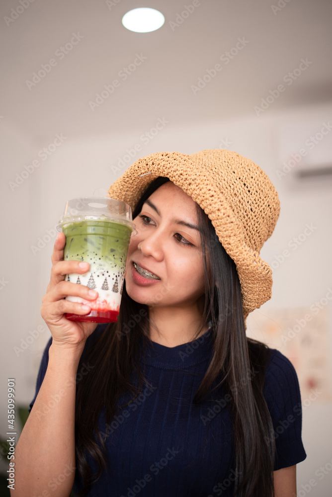 An image of a beautiful Asian woman holding a drink She is at a coffee shop in Thailand. An image of a beautiful Asian woman holding a drink She is at a coffee shop in Thailand.