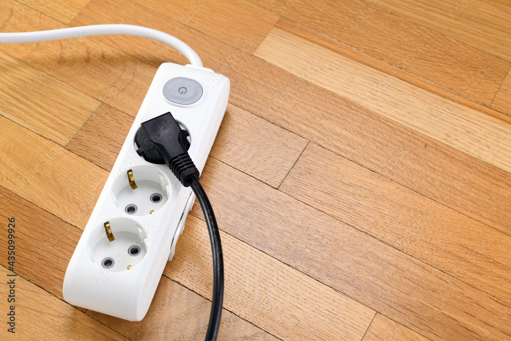 White extension cord with three outlets. Power strip with switch for home or office. White extension cord with three outlets. Power strip with switch for home or office.