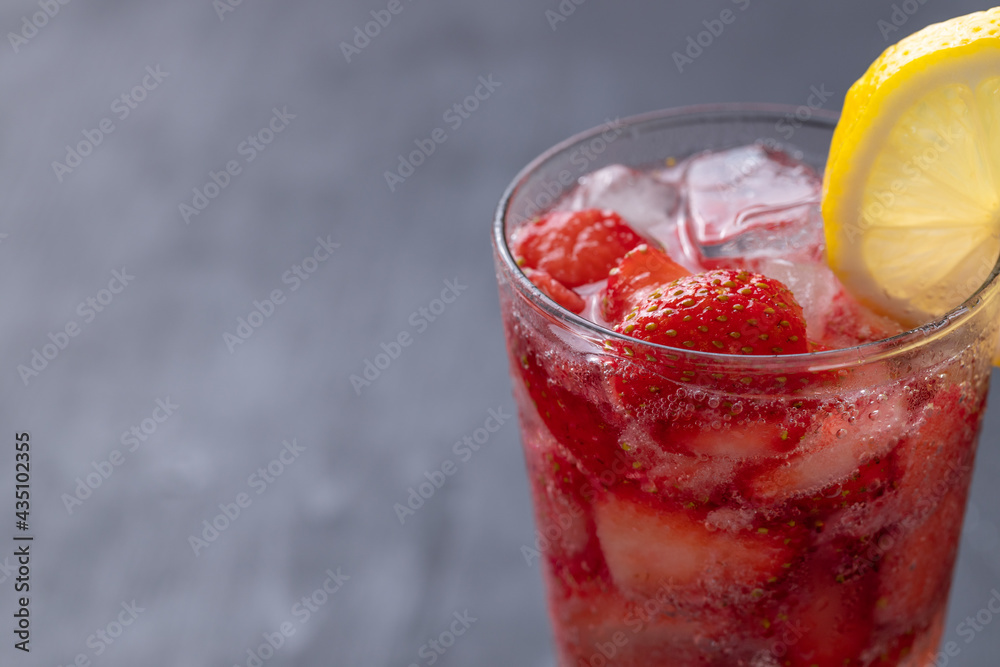 Picture of fresh strawberry juice in a glass full of ice. It looks refreshing and there is a fresh lime slice on top of the glass. Picture of fresh strawberry juice in a glass full of ice. It looks refreshing and there is a fresh lime slice on top of the glass.