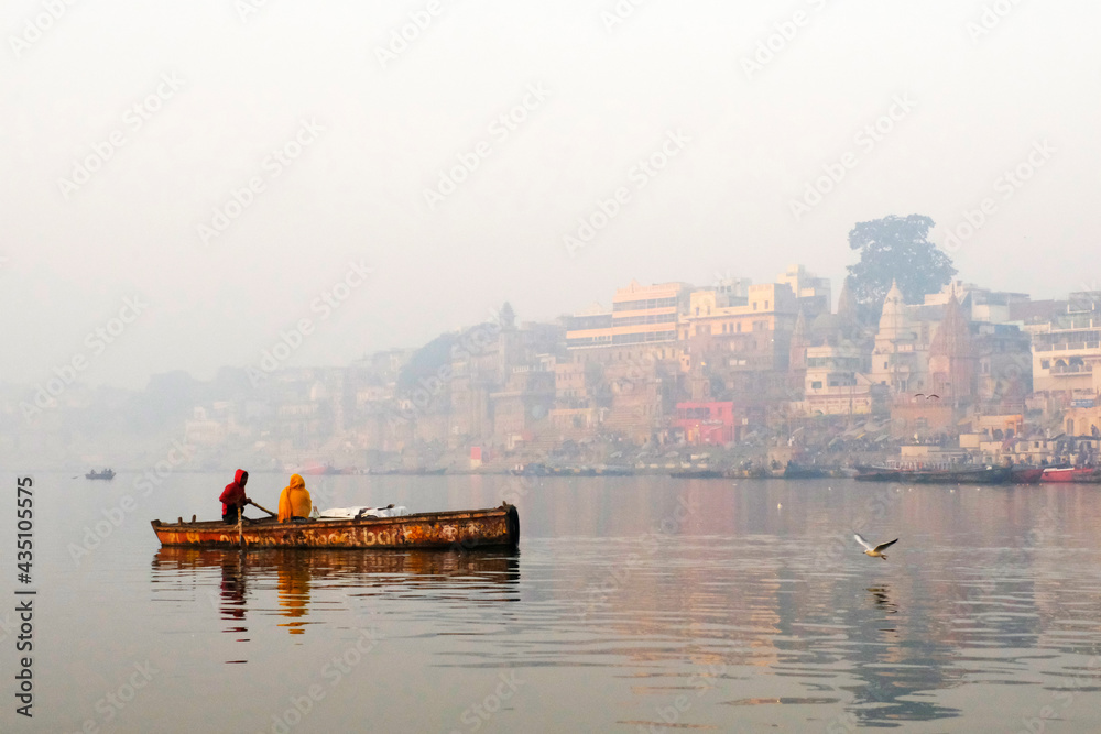 Feb 02, 2021, India, Varanasi Ganges river ghat with ancient city architecture as viewed from a boat on the river at sunset.
