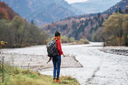 young woman with backpack in the mountains autumn travel tourism landscape shallow water river © SHOTPRIME STUDIO