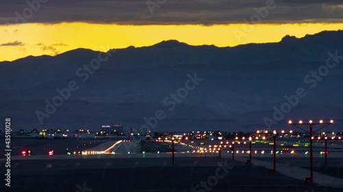 Generic Airport Runway Airplanes Landing Night Timelapse with Aircraft Touching down Arriving at Dusk with Sun Light Surrounding the Mountains in the Background