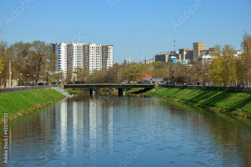 landscape with water canal and distant houses behind the bridge in kharkiv, Ukraine © Mykola