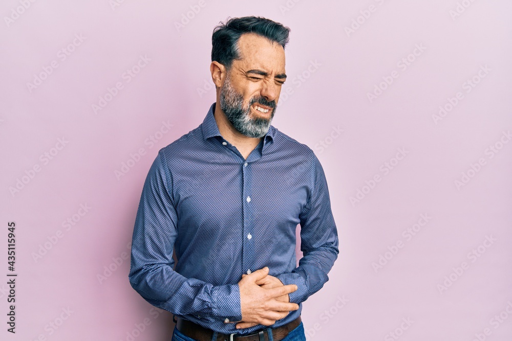 Middle age man with beard and grey hair wearing business clothes with hand  on stomach because nausea, painful disease feeling unwell. ache concept.  Stock Photo | Adobe Stock