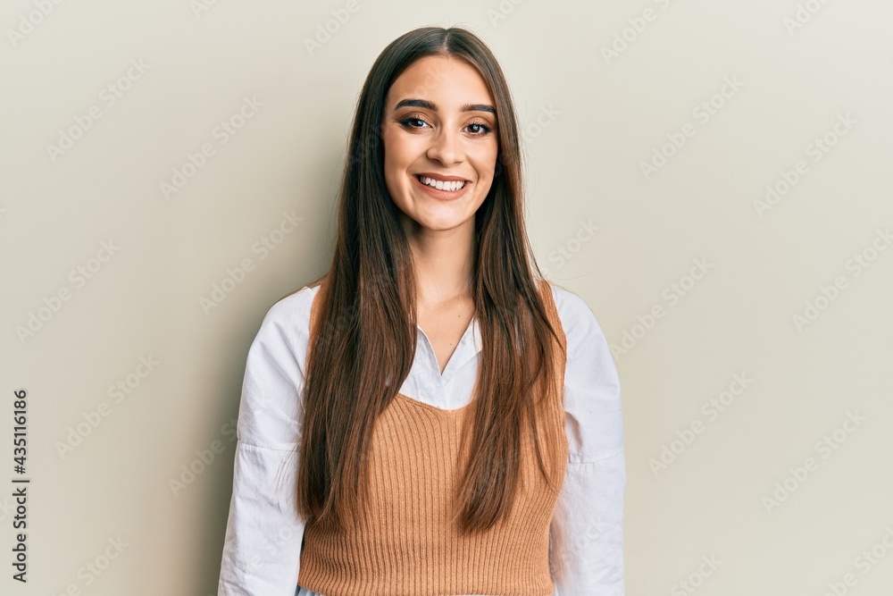 Obraz premium Beautiful brunette young woman wearing casual clothes with a happy and cool smile on face. lucky person.