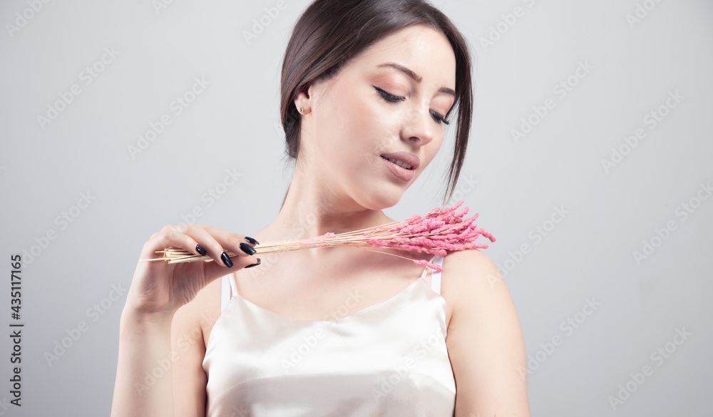 beautiful woman holding pink grass beautiful woman holding pink grass
