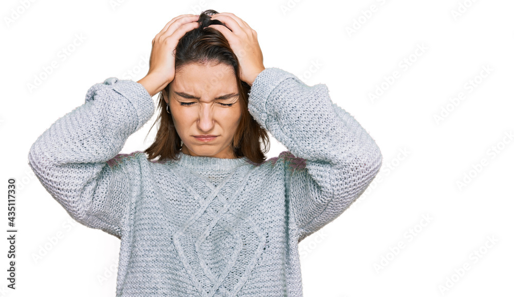 Young caucasian girl wearing casual clothes suffering from headache desperate and stressed because pain and migraine. hands on head. Young caucasian girl wearing casual clothes suffering from headache desperate and stressed because pain and migraine. hands on head.