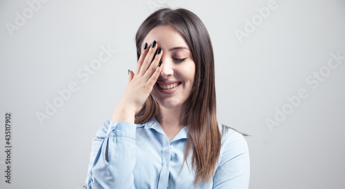 happy embarrassing woman hand in face