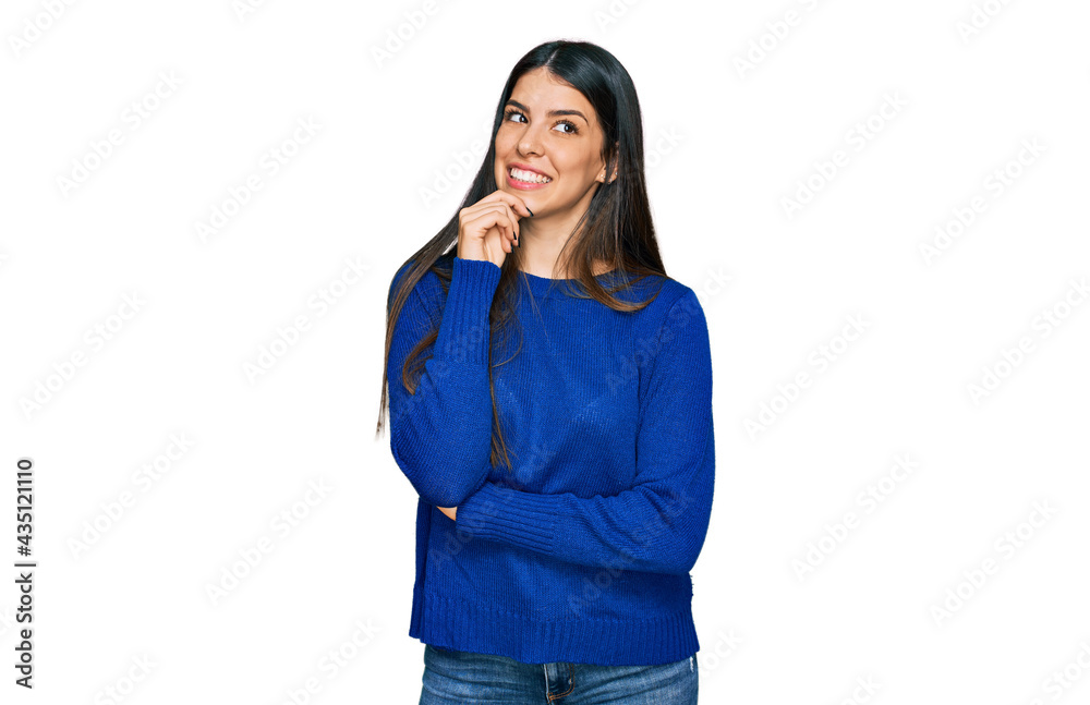 Young hispanic woman wearing casual clothes looking confident at the camera with smile with crossed arms and hand raised on chin. thinking positive.