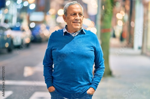 Senior grey-haired man smiling happy standing at the city. © Krakenimages.com