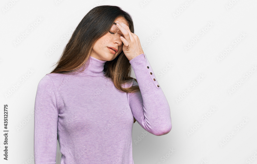 Young beautiful teen girl wearing turtleneck sweater tired rubbing nose and eyes feeling fatigue and headache. stress and frustration concept. Young beautiful teen girl wearing turtleneck sweater tired rubbing nose and eyes feeling fatigue and headache. stress and frustration concept.