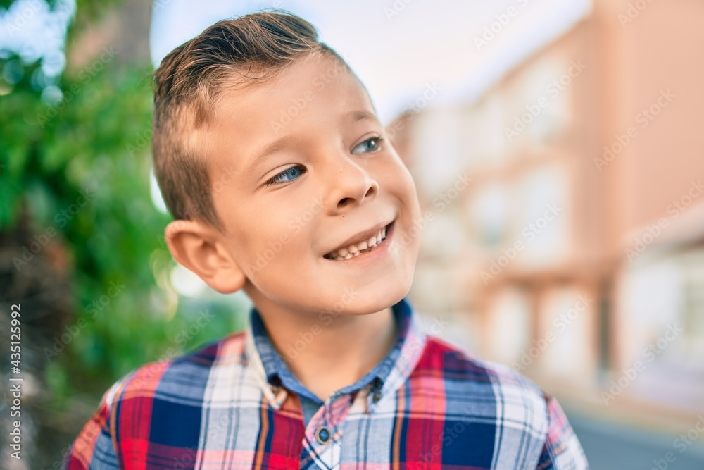 Adorable caucasian boy smiling happy standing at the city. Adorable caucasian boy smiling happy standing at the city.