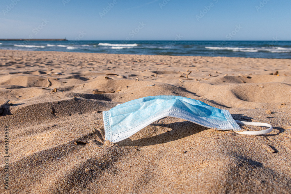 Mask thrown and abandoned in the sand on the beach. Mask thrown and abandoned in the sand on the beach.