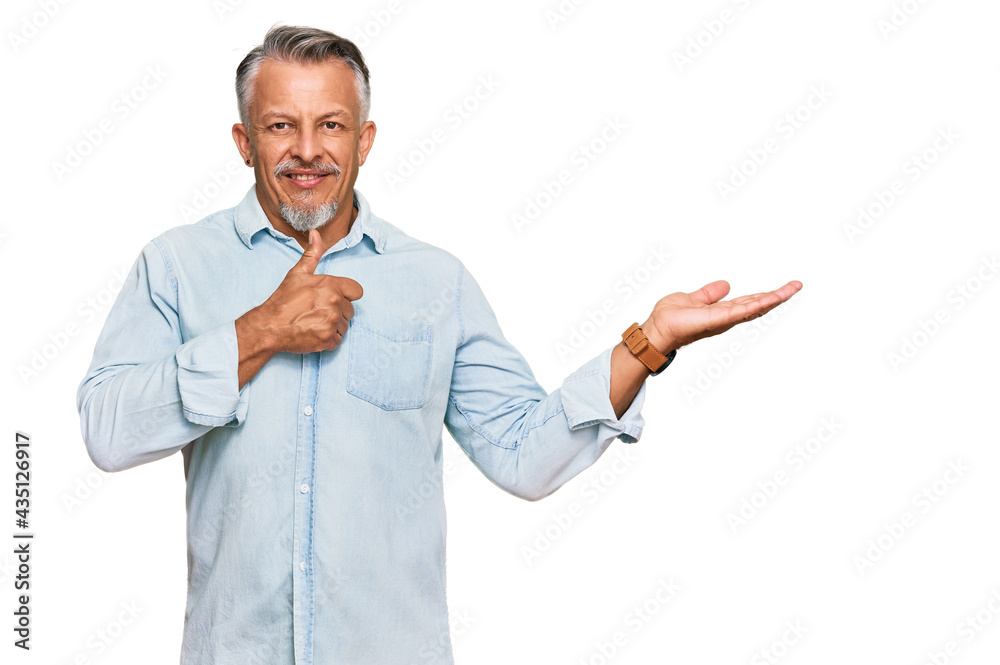 Middle age grey-haired man wearing casual clothes showing palm hand and doing ok gesture with thumbs up, smiling happy and cheerful Middle age grey-haired man wearing casual clothes showing palm hand and doing ok gesture with thumbs up, smiling happy and cheerful