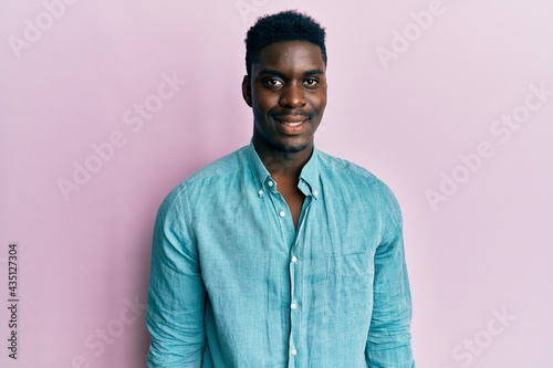 Handsome black man wearing casual clothes with a happy and cool smile on face. lucky person. © Krakenimages.com