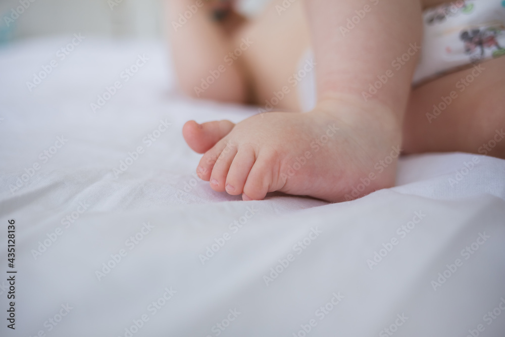 close-up of a toddler's bare feet on a blanket with room for text close-up of a toddler's bare feet on a blanket with room for text