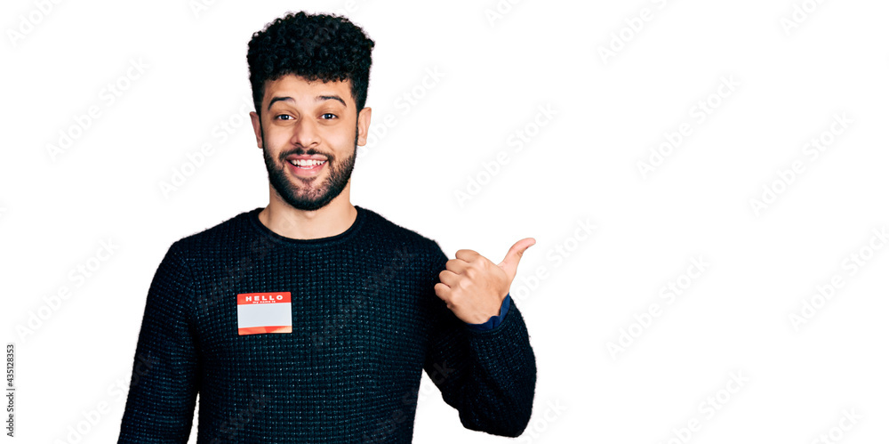 Young arab man with beard wearing hello my name is sticker ...