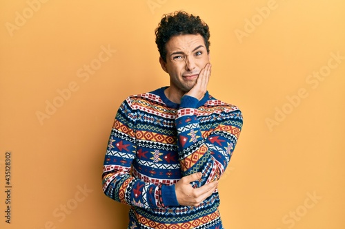Young handsome man wearing casual winter sweater thinking looking tired and bored with depression problems with crossed arms.