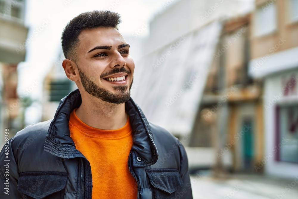 Handsome hispanic man with beard smiling happy and confident at the city wearing winter coat Handsome hispanic man with beard smiling happy and confident at the city wearing winter coat
