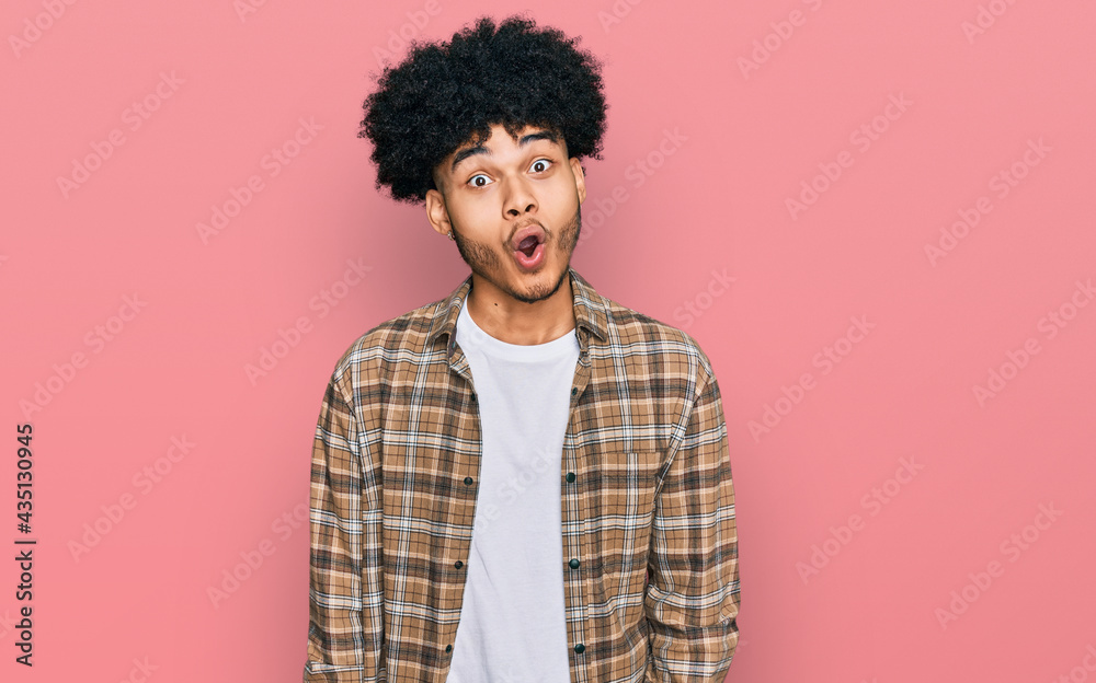 Young african american man with afro hair wearing casual clothes afraid and shocked with surprise expression, fear and excited face. Young african american man with afro hair wearing casual clothes afraid and shocked with surprise expression, fear and excited face.