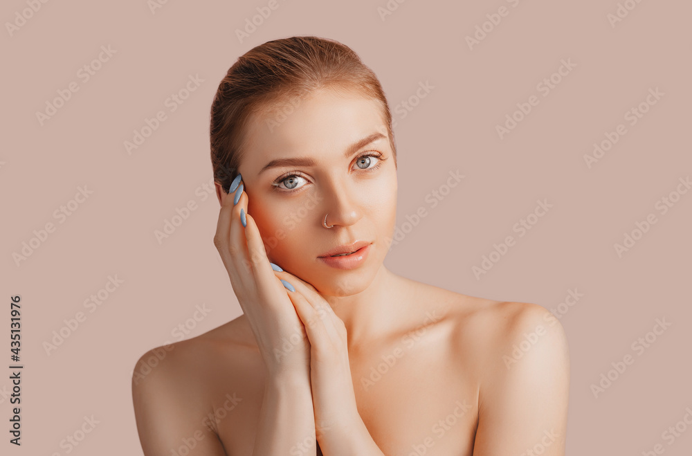 Beautiful sensual young girl with clean skin on a beige background with a mockup. Topless woman. The concept of spa treatments, natural beauty and care, youth, cream and mask, freshness Beautiful sensual young girl with clean skin on a beige background with a mockup. Topless woman. The concept of spa treatments, natural beauty and care, youth, cream and mask, freshness