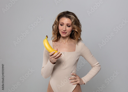 the model holds a banana in her hands