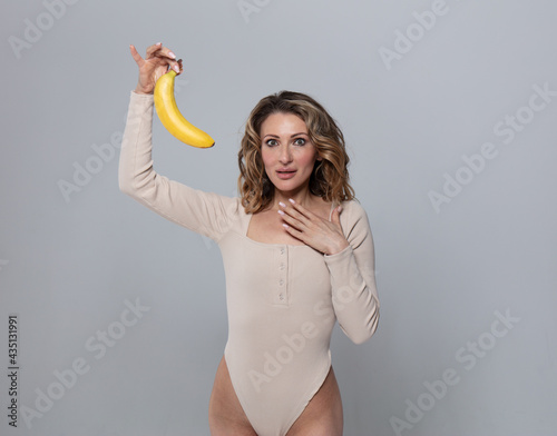 the model holds a banana in her hands