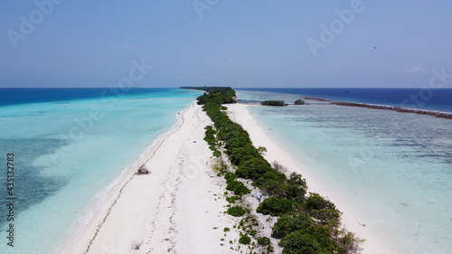 Maldives resort island drone aerial view  Indian ocean atoll nature beach and palm forest  leisure tourist luxury vacation