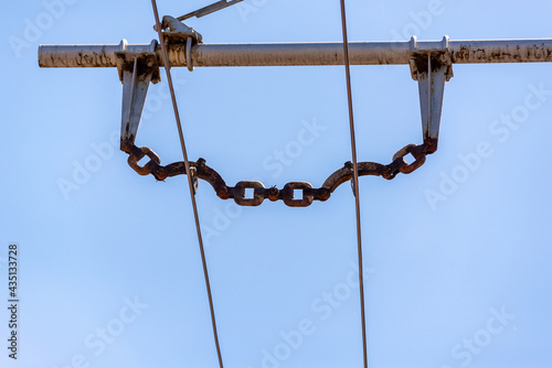 Trolleybus wires against the blue sky.