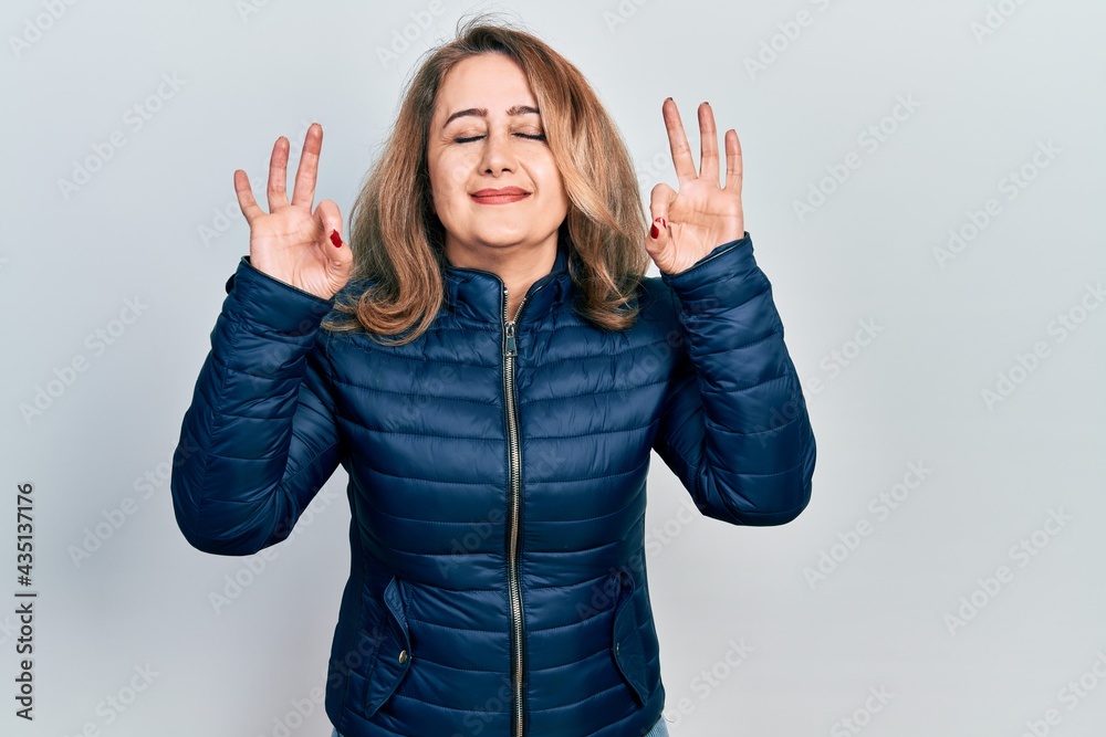 Middle age caucasian woman wearing casual clothes relax and smiling with eyes closed doing meditation gesture with fingers. yoga concept. Middle age caucasian woman wearing casual clothes relax and smiling with eyes closed doing meditation gesture with fingers. yoga concept.