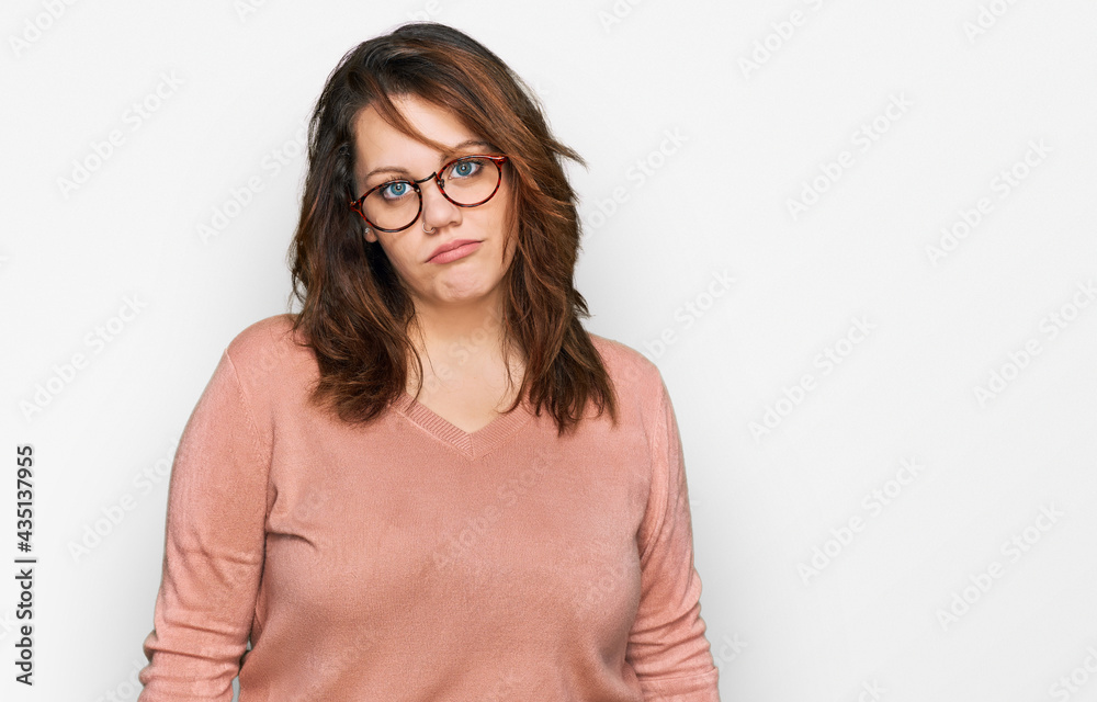 Young plus size woman wearing casual clothes and glasses looking sleepy and tired, exhausted for fatigue and hangover, lazy eyes in the morning. Young plus size woman wearing casual clothes and glasses looking sleepy and tired, exhausted for fatigue and hangover, lazy eyes in the morning.
