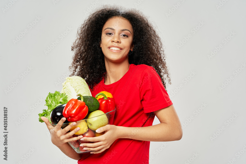 woman with curly hair in a red t-shirt vegetables healthy food woman with curly hair in a red t-shirt vegetables healthy food