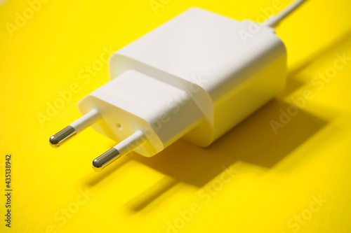 Charging 220 volts for a phone with a usb connector on a yellow background