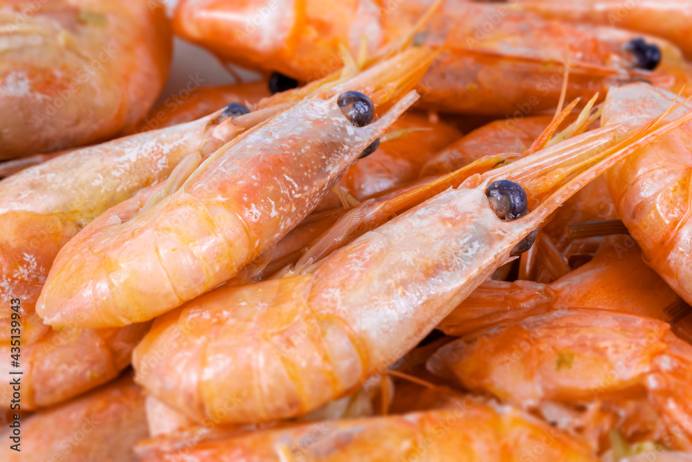 Boiled unpeeled shrimp and prawns, close-up. Seafood of the order of crustaceans. Seafood delicacy